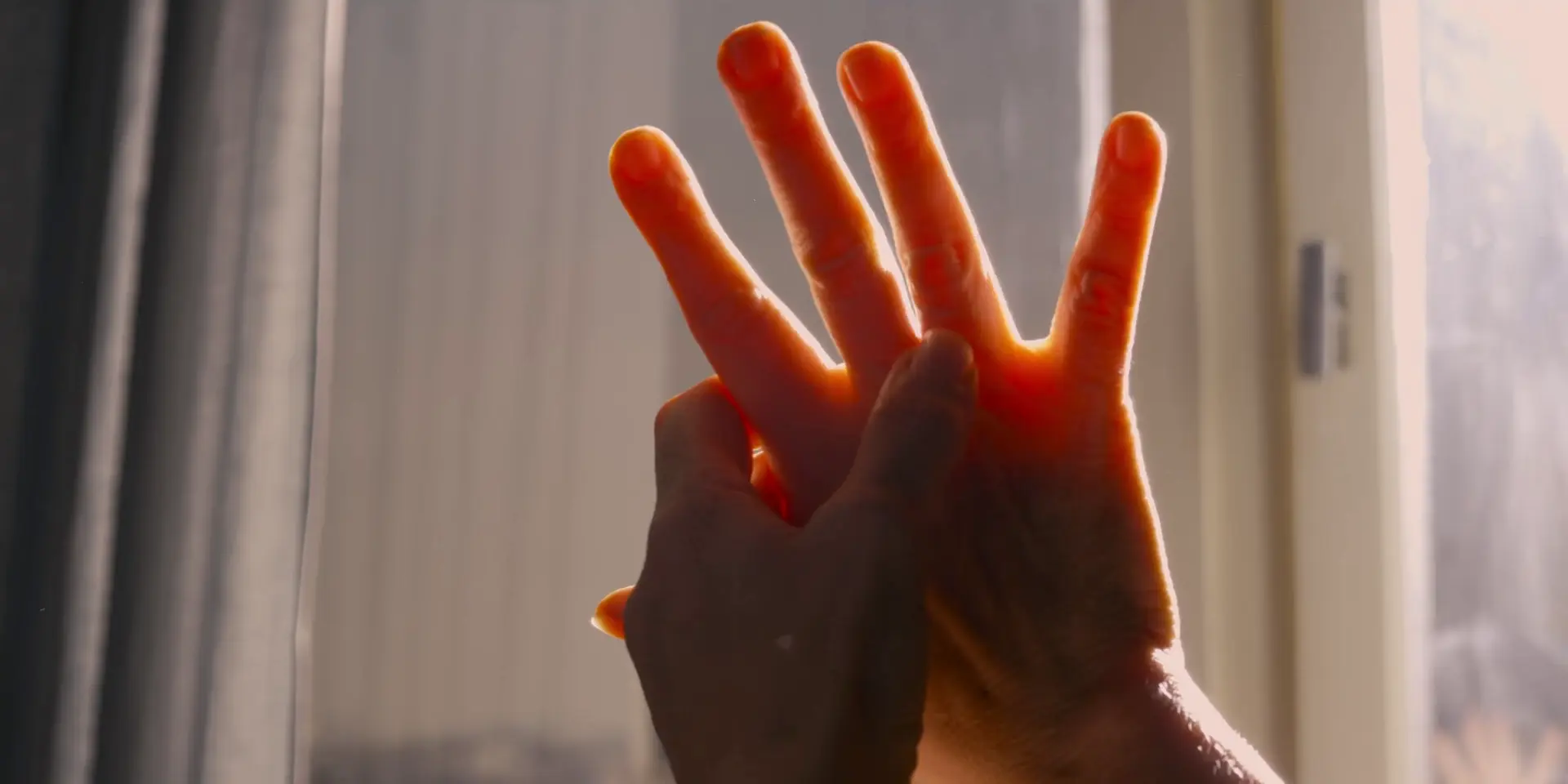 “Dos manos entrelazadas a contraluz, imagen simbólica sobre los vínculos afectivos y la intimidad en la era de la inteligencia artificial”